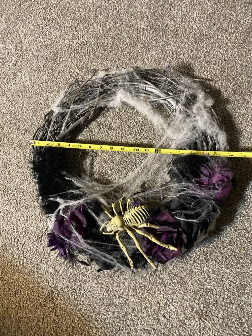 Halloween wreath with spider skeleton, flowers and cobwebs